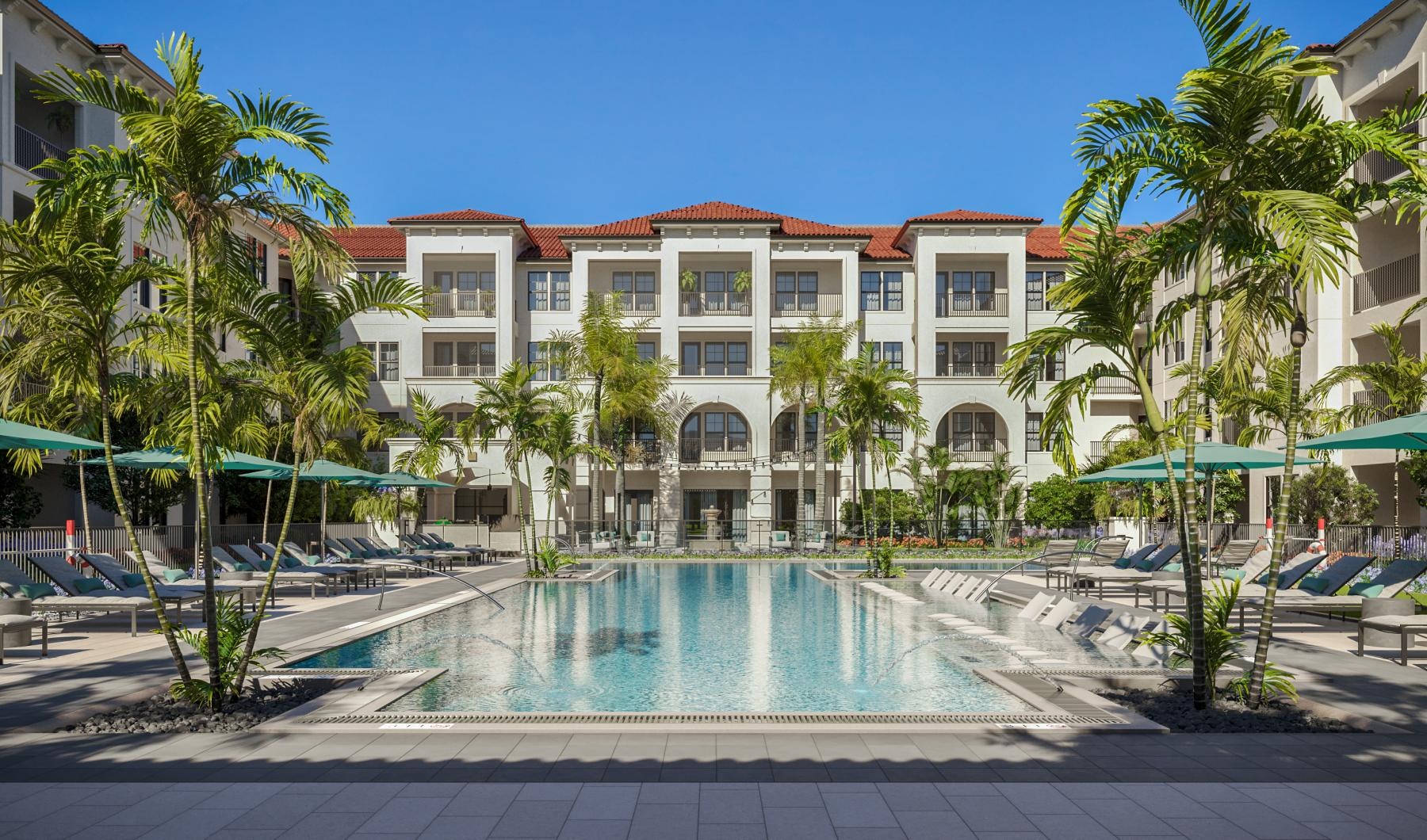 a large building with a pool in front of it